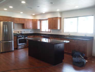 Belinda's kitchen remodel We knocked down the wall between the living room and kitchen to make this large open area with new flooring, cabinets and gra
