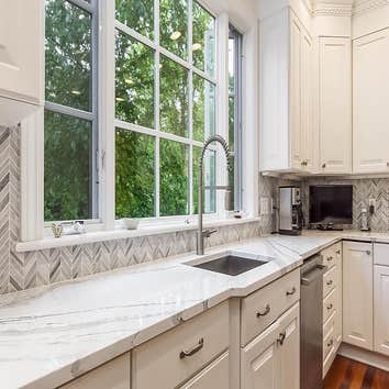 A Custom Island w/ Maple Cabinetry ?AMAZING? Features: A Custom Island with Maple Cabinetry painted Gauntlet Gray, plus brushed nickel hardware and Bri