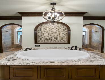 Lake House Master Bath Remodel This large lake house was originally built with builder-grade materials in the private areas of the home, which did not 