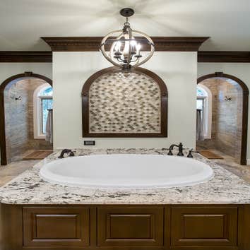 Lake House Master Bath Remodel This large lake house was originally built with builder-grade materials in the private areas of the home, which did not 