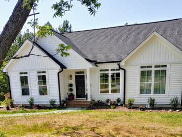 Photos by Mills Builders LLC #1 1 1/2 story with 3 beds/2baths down, 1 bath/ 1bed and bonus room upstairs on 1 acre land. Quarzite countertops with whi