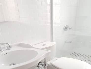 Upper West Side Our work for this project included full gut renovation with exposed brick wall, Calacatta countertop, and glass shower. Bathroom with c