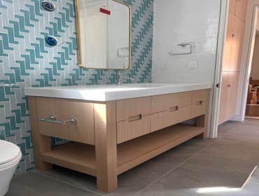 Custom Kitchen Cabinets, Vanity & Entertainment Center Custom carpentry work by Kyvos Construction, including vanity, kitchen cabinets & TV stand.