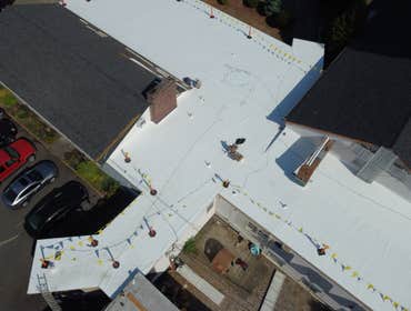 Isaac Roof Construction Commercial Roof Project Flat roof replacement with a minimum R-value of R-30 and a Class A Fire rating.