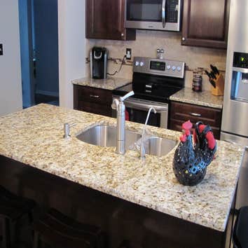 Behagan - Aristokraft cabinetry - Granite Aristokraft cabinetry - Eastland Door in Umber color.
Backsplash was a 3x6 durango honed with a caramel Trav