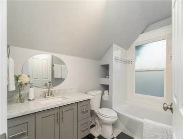 1908-bathroom remodel new cabinet, granite countertop, sink, toilet and bathtub with marble black and white floor.