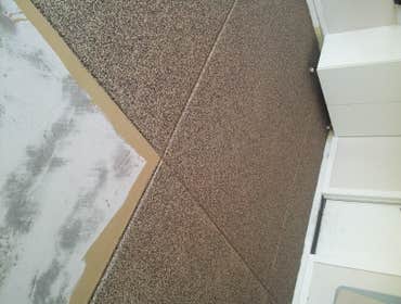 Champion Decor And Coatings LLC Garage floor with full broadcast vinyl chip, polyaspartic topcoat.
