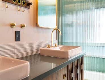 Gabryelle & Ed | Primary Bathroom This remodel turned a cramped shower into a spa-like sanctuary with green tiles, teak ceiling, and gold fixtures. Fro