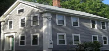 Greek Revival Exterior We removed two layers of siding and all rotting trim and performed extensive repairs to the original plank sheathing, replacing 