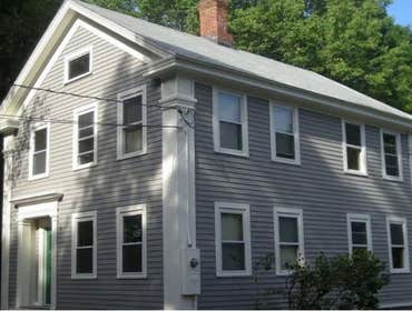 Greek Revival Exterior We removed two layers of siding and all rotting trim and performed extensive repairs to the original plank sheathing, replacing 