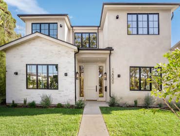 Navy A newly built traditional home by Smart Builders, known for thoughtful craftsmanship and custom design, set on a charming corner lot along tree-li