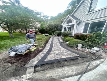 Photos by Bradstone Paving and Masonry Inc #1 Install new front patio in nicklock 6B9 granite city permanible pavers with raven 6B9 double Edge