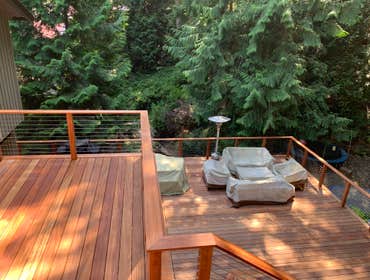 Photos by Maiden Construction LLC #8 Custom deck on two levels with Tiger wood decking and cable railing.