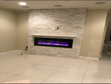 Photos by Hsd Masonry #3 A fireplace was installed on a flat wall. A wooden structure is applied and an electric fire box is installed and then covere