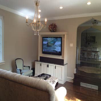 Lower Merion Living room Living room update with new recessed lighting, chandelier,custom built in and marble fireplace. This job was done in a few pha