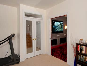 Red and Black Home Theater Converted storage space in the basement to a home theater with stadium seating and lobby area for treats and snacks.