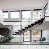 Project 15-461 The interior layout and large windows in this custom home provide the occupants a stunning views on the lake and mountains of this regi