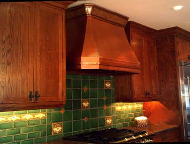 Luminescent Series Range Hood patented Luminescent Series copper range hood. Finished in medium copper and illuminated crown with amber mica diffuser