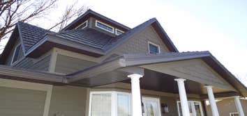 Lakefield Installed Classic Metal Roofing Systems Country Manor Shake aluminum shingles in Shake Gray.