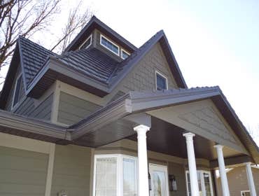 Lakefield Installed Classic Metal Roofing Systems Country Manor Shake aluminum shingles in Shake Gray.
