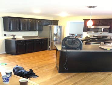 Black Kitchen cabinets from Spraymasters Inc removed desk from 1990's kitchen, added crown, painted all matte black.