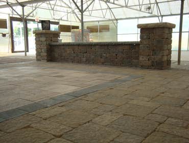 AreA Landscape Supply Inc. - Interior Displays Interior showroom designed with paver patio ideas and vertical focal points as well, such as seat walls 