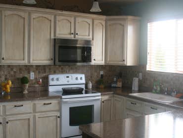 Clearfield We refinished the kitchen cabinets and counters, install a new tile back splash and replace the pantry door.
