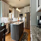 Photos by Lvs Revival Inc #1 Remove existing cabinet design and provide new cabinets. Install new cabinets and granite countertop. Hook up sink and app