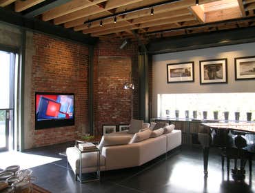 Residential Hip Loft This was designed by legendary architect WHy. Shown in the loft is a recessed TV and multi channel surround sound bar custom built