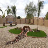 Photos by Desert Xeriscapes Inc #2 waterfalls, artificial grass, pygmy palms, flagstone bridge and walkway