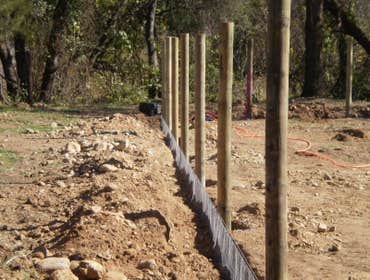 Fence Enclosure for Rescued Cats 850' of 6' high 2" x 4" fence with 5 gates. Project includes underground gopher wire along fence line to prevent coyo