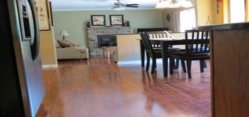 A family's living room and kitchen installed with laminate This project started out with us removing the old existing carpet in the living room and old