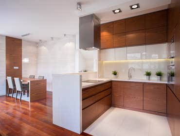 Clean kitchen with white tops in contemporary elegant house