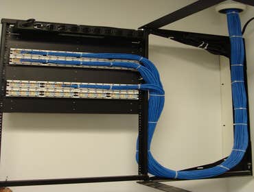 Cat 6 Cabling with a wall mount rack This customer wanted a wall mount rack for the reason of limited space, so we installed a Swing gate rack to fit t