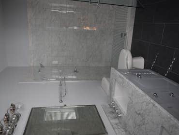 Inman Park Bathroom Renovation Project entailed removing existing Jacuzzi tub/shower combo that was built upon a raised platform. Eliminated that to c