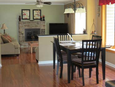 A family's living room and kitchen installed with laminate This project started out with us removing the old existing carpet in the living room and old