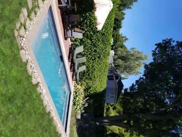 Tranquil Backyard Pool As you step into this remarkable sanctuary, a glistening swimming pool takes center stage, surrounded by paver slabs that gracef