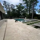 Huntersville Luxury Pool & Spa Project – Travertine, Turf, Landscaping & Lighting This high-end backyard transformation in Huntersville, NC features a 