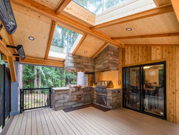 Tippett Project This project transformed a standard backyard into a fully integrated outdoor living space designed for year-round use. The centerpiece 