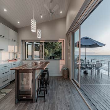 The Beach House This stunning beach house on Lake Michigan offers a seamless blend of modern design and natural beauty. Located on a picturesque water