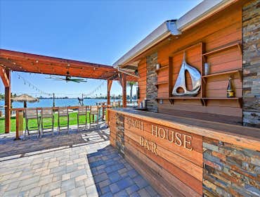 Outdoor Kitchen & Complete landscaping overhaul A shaded outdoor kitchen & bar with a deck, a fire pit area & a hardscaped bench
