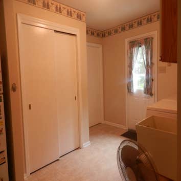 Interior Motivez Painting Family room painted in Crushed Peanut. Cathedral accent wall painted in Stone Harbor.
Kitchen and dining area painted in It