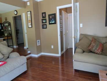 A family's living room and kitchen installed with laminate This project started out with us removing the old existing carpet in the living room and old