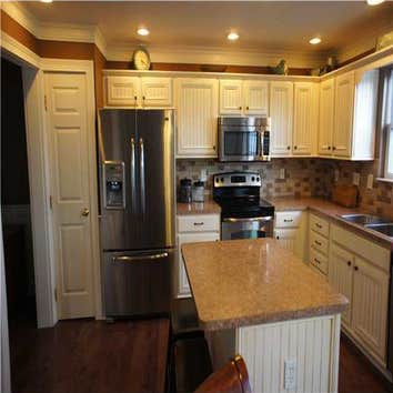 Delaware, Ohio Kitchen Remodel Added trim and bead board to existing oak kitchen cabinets then painted and distressed. Added tile back splash, instal