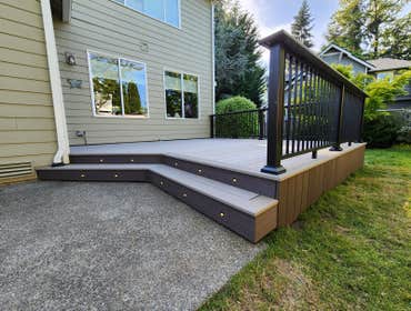 Modern PVC Deck with Integrated LED Stair Lighting This premium low-maintenance deck was built using TimberTech Advanced PVC decking in Coastline with 