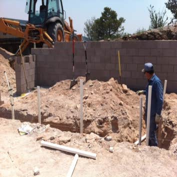 Nice little project in the mountains of Ojo Caliente Eddie senior in the trenches roughing-in some drainage pipe.