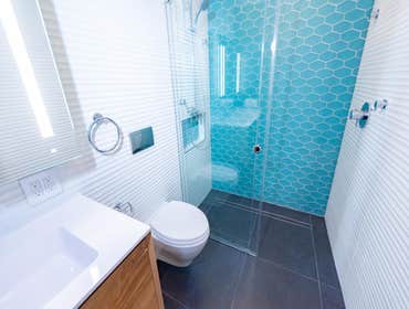 Corbett Ave, San Francisco Bathroom remodeling that converges a sophisticated and serene color palette with oscillating wall surfaces to create a calmi