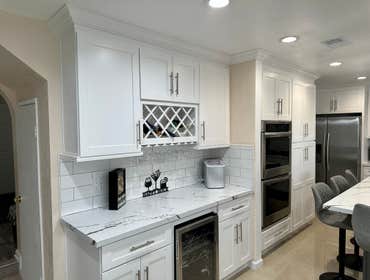 Kitchen Remodel In Moreno Valley Ca White Shaker Cabinets with Calacata Alaska Quartz and White Subway Tile 3X6 Full Backsplash
