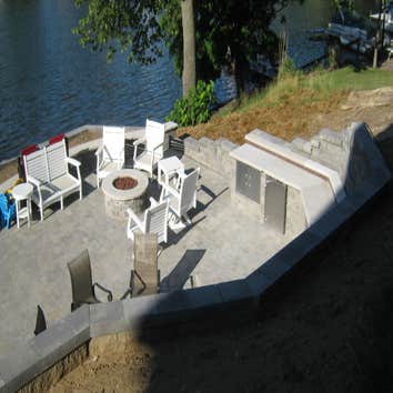 New Patio and Retaining Walls from Archadeck of Northeastern Indiana For this project, we built a new patio and retaining walls cut into a steep hill l