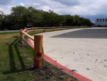 Photos by Weise Choice Construction #1 Cedar split rail fence added for aesthetic purposes and a deterrent for trucks driving in the grass.